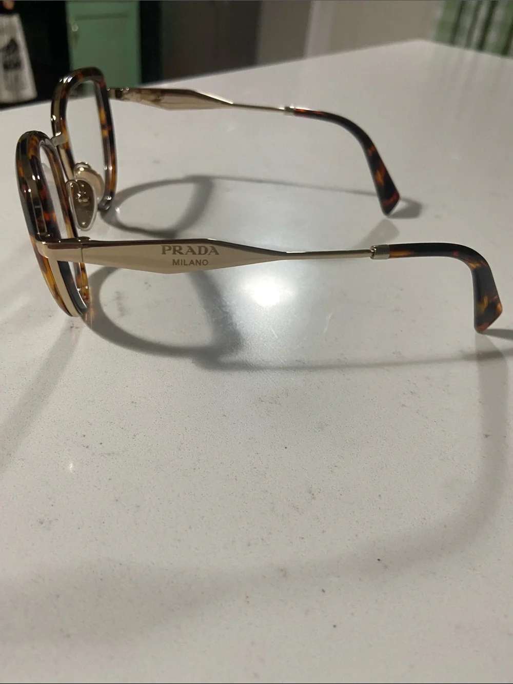 Prada Tortoiseshell Cat-Eye Glasses with Gold Trim